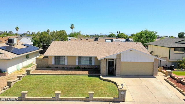 5349 W Acapulco Ln, Glendale, AZ 85306 - ranch-style house featuring brick siding, a garage, driveway, a front lawn, and a shingled roof