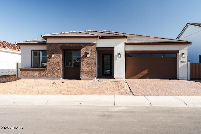 1284 E Coconino Way, Gilbert, AZ 85298 - prairie-style house with decorative driveway, a garage, and stucco siding