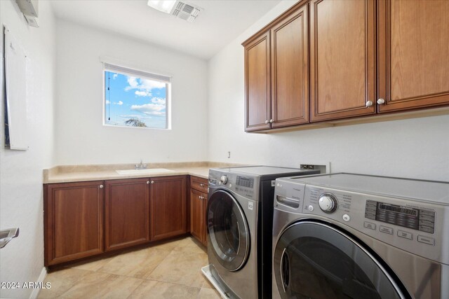 laundry room featuring sink, cabinets, washer and dryer, and light tile patterned flooring