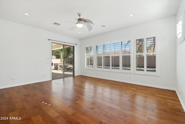 unfurnished room featuring ceiling fan and dark hardwood / wood-style floors