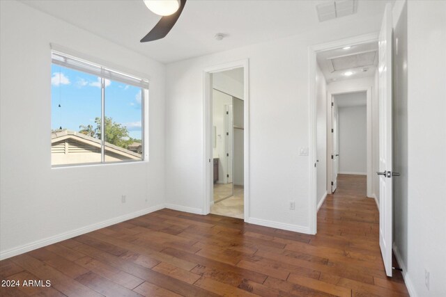 unfurnished bedroom with dark wood-type flooring and ceiling fan