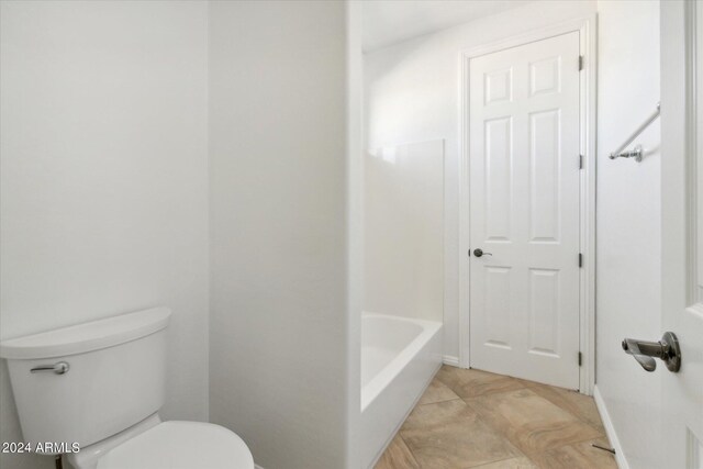 bathroom with a bathing tub and toilet