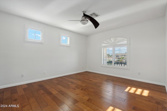 unfurnished room with dark hardwood / wood-style flooring and ceiling fan