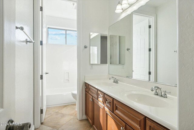 bathroom with vanity, tile patterned floors, and toilet