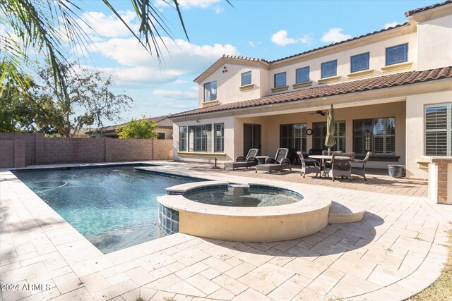 view of pool featuring an in ground hot tub, ceiling fan, and a patio area