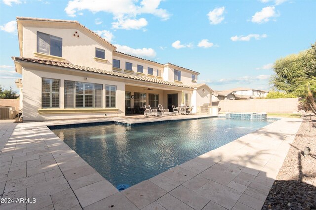 exterior space featuring central AC, ceiling fan, a fenced in pool, and a patio area