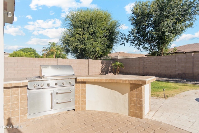 view of patio with a grill and an outdoor kitchen