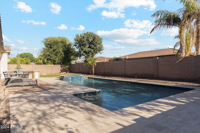 view of pool with an in ground hot tub and a patio area