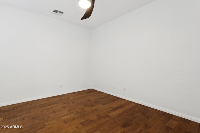 unfurnished room with dark wood-type flooring and ceiling fan