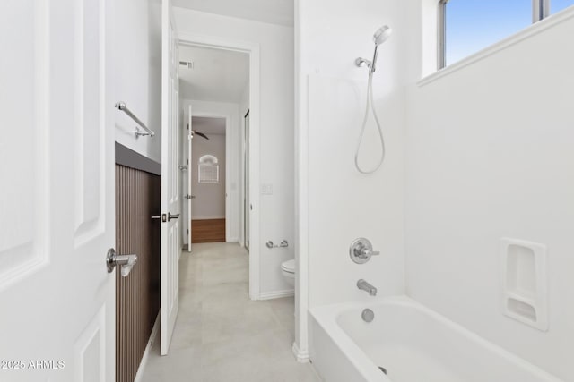 bathroom with shower / bath combination and toilet