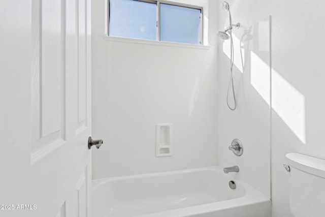 bathroom with bathing tub / shower combination and toilet