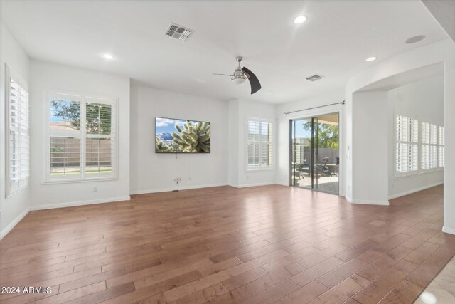 empty room with hardwood / wood-style flooring and ceiling fan