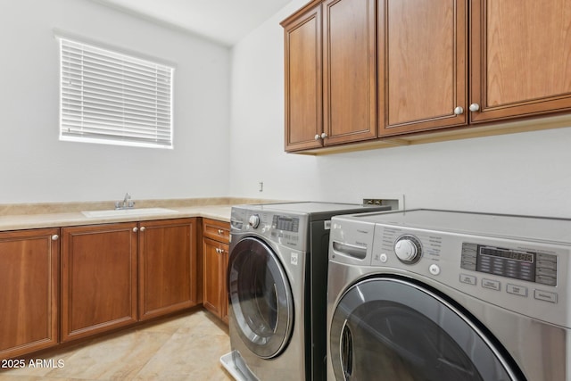 laundry area featuring cabinets, sink, and washing machine and dryer