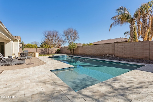 view of swimming pool with an in ground hot tub and a patio