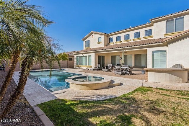 back of house featuring a swimming pool with hot tub, ceiling fan, and a patio area