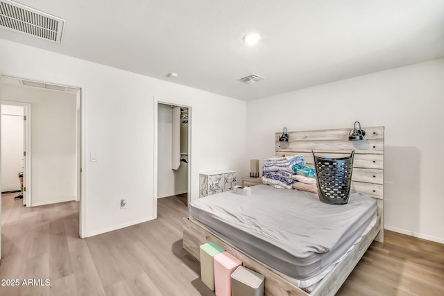 25787 W Allen St, Buckeye, AZ 85326 - bedroom with light wood-style floors, baseboards, and a spacious closet