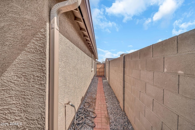 25787 W Allen St, Buckeye, AZ 85326 - view of property exterior featuring stucco siding and a gate