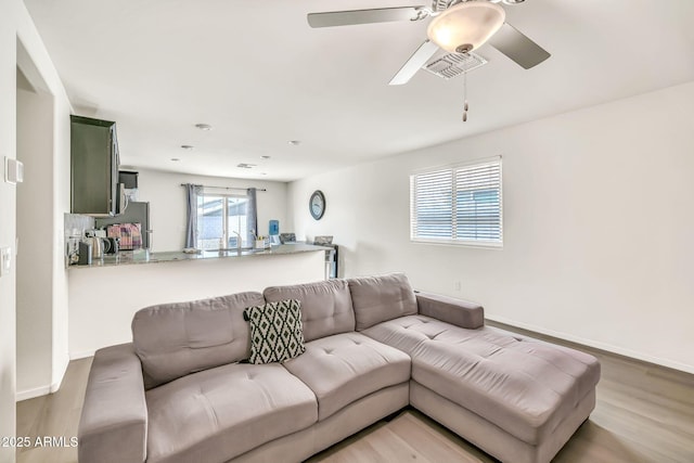 25787 W Allen St, Buckeye, AZ 85326 - living area featuring a ceiling fan, wood finished floors, and baseboards