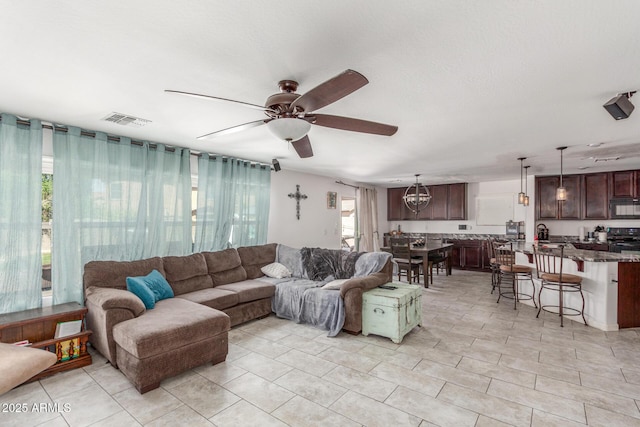12128 W Range Mule Dr, Peoria, AZ 85383 - living area with a ceiling fan and light tile patterned floors