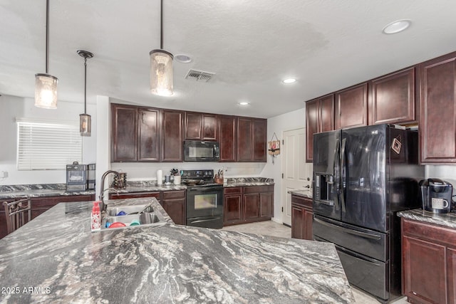 12128 W Range Mule Dr, Peoria, AZ 85383 - kitchen with black appliances, a sink, pendant lighting, recessed lighting, and dark stone counters