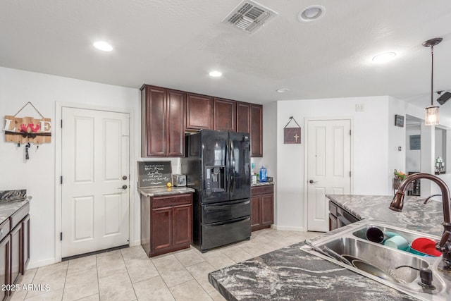 12128 W Range Mule Dr, Peoria, AZ 85383 - kitchen with black refrigerator with ice dispenser, a sink, recessed lighting, light tile patterned floors, and decorative light fixtures