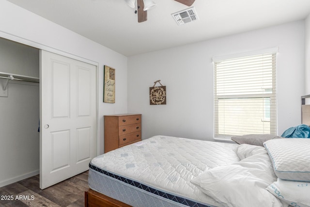 12128 W Range Mule Dr, Peoria, AZ 85383 - bedroom featuring dark wood finished floors, a closet, multiple windows, and baseboards