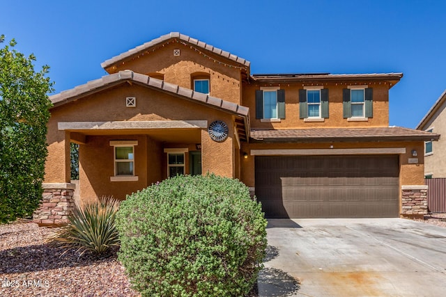 12128 W Range Mule Dr, Peoria, AZ 85383 - view of front of house featuring concrete driveway, an attached garage, and stucco siding