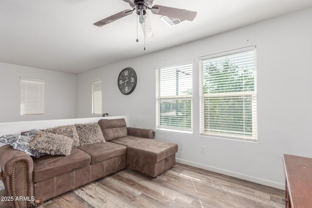 12128 W Range Mule Dr, Peoria, AZ 85383 - living room with a ceiling fan, light wood finished floors, and baseboards
