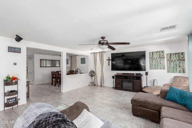 12128 W Range Mule Dr, Peoria, AZ 85383 - living area with light tile patterned floors, a ceiling fan, and baseboards