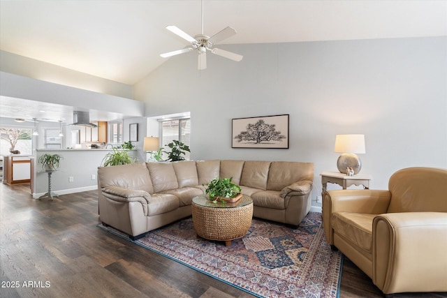 living area with high vaulted ceiling, wood finished floors, baseboards, and ceiling fan