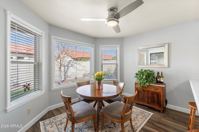 dining room featuring ceiling fan, baseboards, and wood finished floors