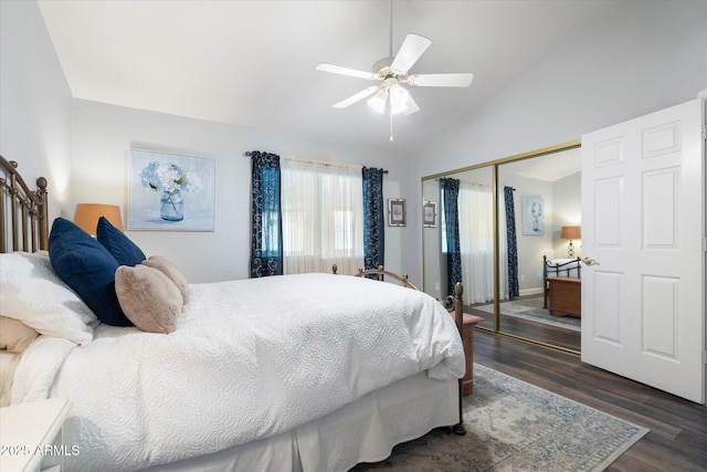 bedroom with ceiling fan, a closet, dark wood-style floors, and vaulted ceiling