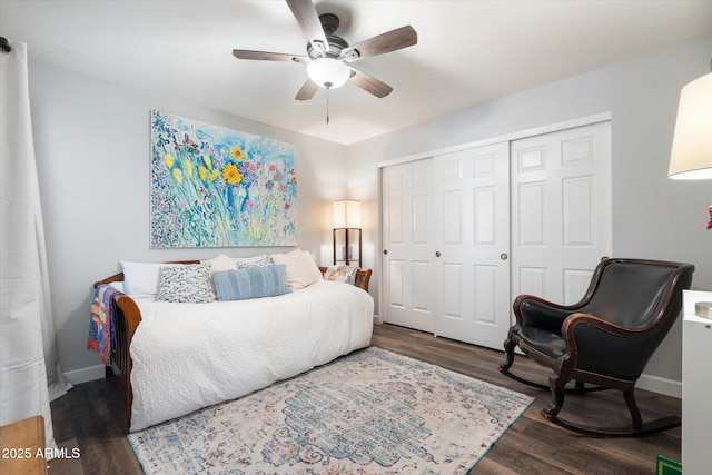 bedroom featuring a ceiling fan, wood finished floors, a closet, and baseboards