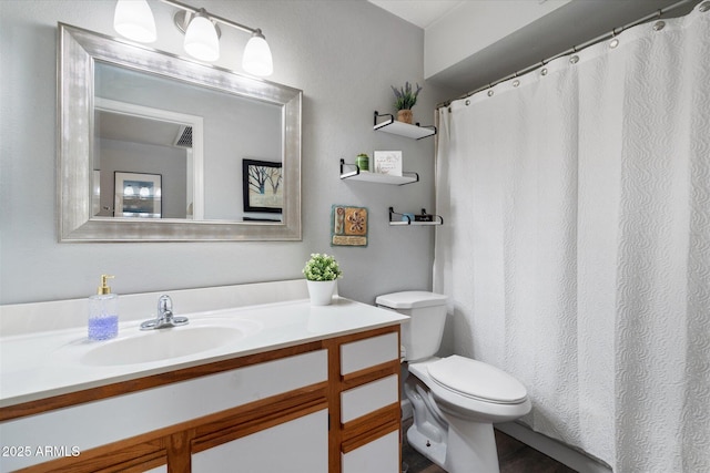 full bathroom with toilet and vanity