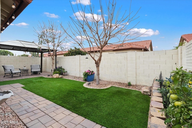 view of yard featuring a gazebo, a fenced backyard, and a patio area