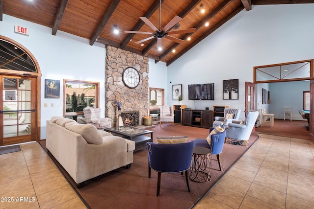 living room with tile patterned floors, high vaulted ceiling, a fireplace, and wood ceiling