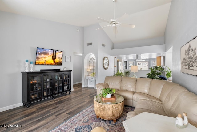 living room featuring visible vents, baseboards, high vaulted ceiling, and wood finished floors