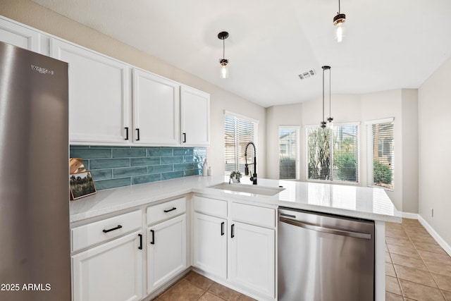 16424 S 46th Way, Phoenix, AZ 85048 - kitchen featuring stainless steel appliances, a sink, a peninsula, light tile patterned floors, and backsplash