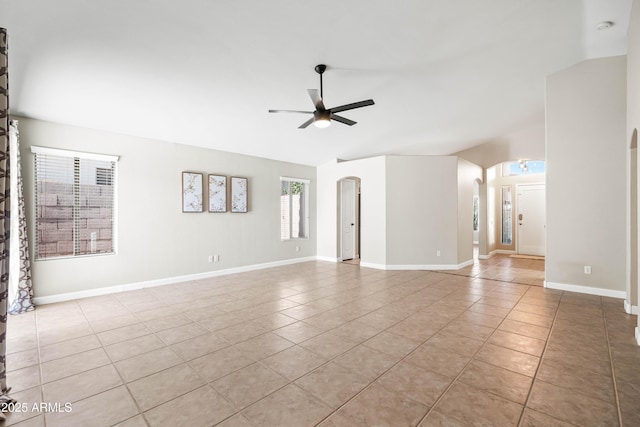 16424 S 46th Way, Phoenix, AZ 85048 - unfurnished living room with light tile patterned floors, ceiling fan, arched walkways, and baseboards