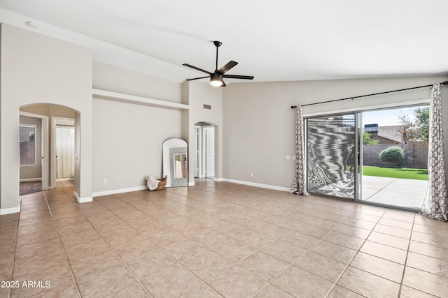 16424 S 46th Way, Phoenix, AZ 85048 - unfurnished living room featuring arched walkways, a ceiling fan, light tile patterned floors, baseboards, and high vaulted ceiling