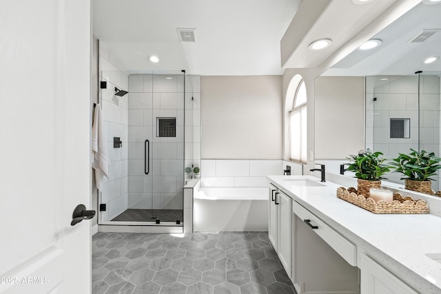 16424 S 46th Way, Phoenix, AZ 85048 - bathroom featuring double vanity, a bath, a stall shower, recessed lighting, and tile patterned flooring
