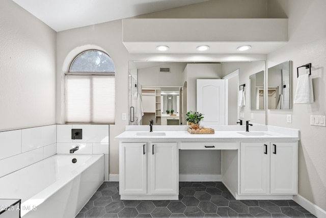 16424 S 46th Way, Phoenix, AZ 85048 - bathroom with a garden tub, double vanity, tile patterned floors, and baseboards