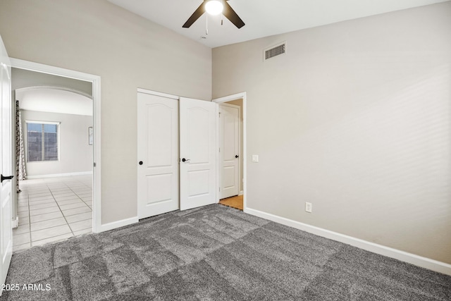 16424 S 46th Way, Phoenix, AZ 85048 - unfurnished bedroom with arched walkways, baseboards, carpet, and tile patterned floors