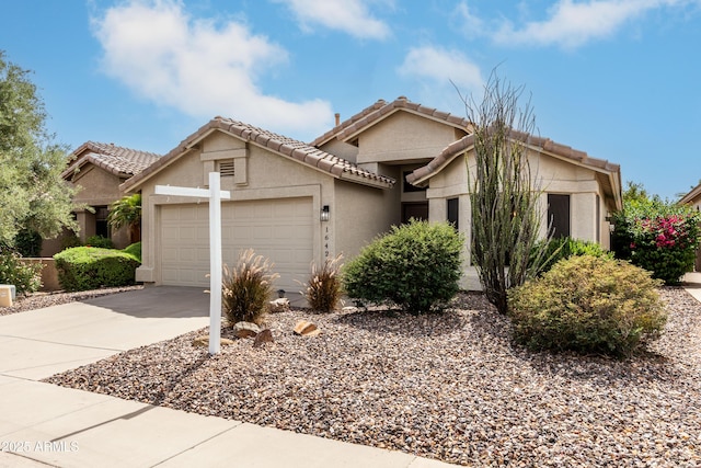 16424 S 46th Way, Phoenix, AZ 85048 - view of front of home featuring an attached garage, concrete driveway, stucco siding, and a tile roof