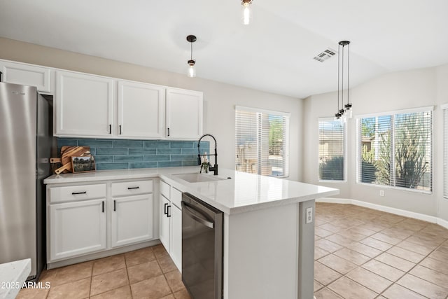 16424 S 46th Way, Phoenix, AZ 85048 - kitchen with stainless steel appliances, a sink, a peninsula, light tile patterned flooring, and backsplash
