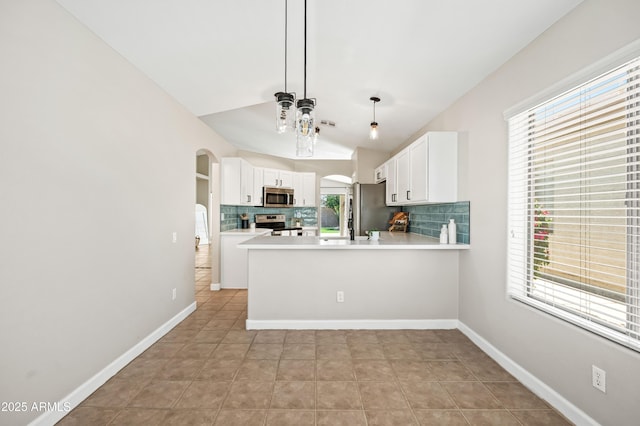 16424 S 46th Way, Phoenix, AZ 85048 - kitchen featuring stainless steel appliances, arched walkways, backsplash, vaulted ceiling, and white cabinets
