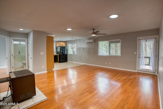 281 S 31st Dr, Show Low, AZ 85901 - unfurnished living room with ceiling fan, light wood-type flooring, baseboards, recessed lighting, and a wall mounted air conditioner