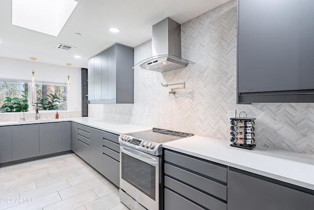 2942 N 81st Pl, Scottsdale, AZ 85251 - kitchen with gray cabinetry, a skylight, sink, wall chimney exhaust hood, and stainless steel range with electric cooktop