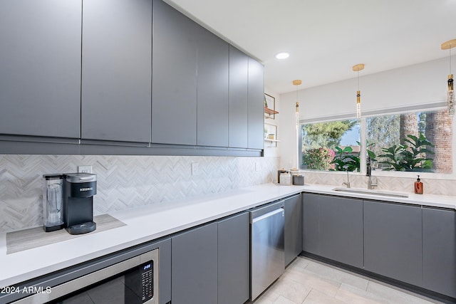 2942 N 81st Pl, Scottsdale, AZ 85251 - kitchen featuring decorative backsplash, stainless steel appliances, hanging light fixtures, and sink