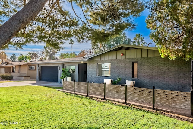 single story home featuring a front lawn and a garage